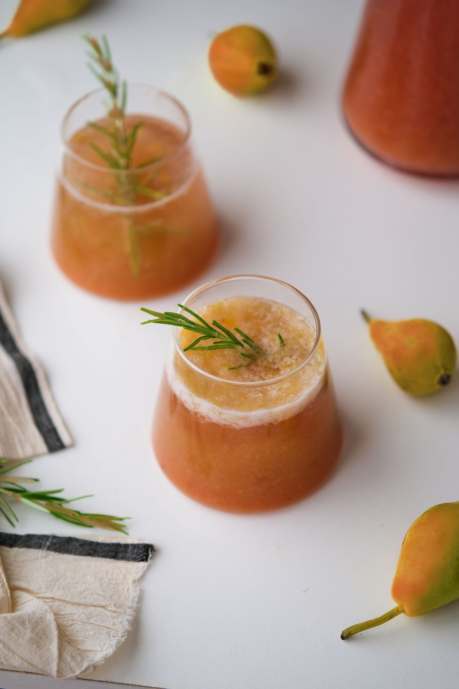Fresh Eden Gold pear and rosemary juice with blushed Eden Gold pears